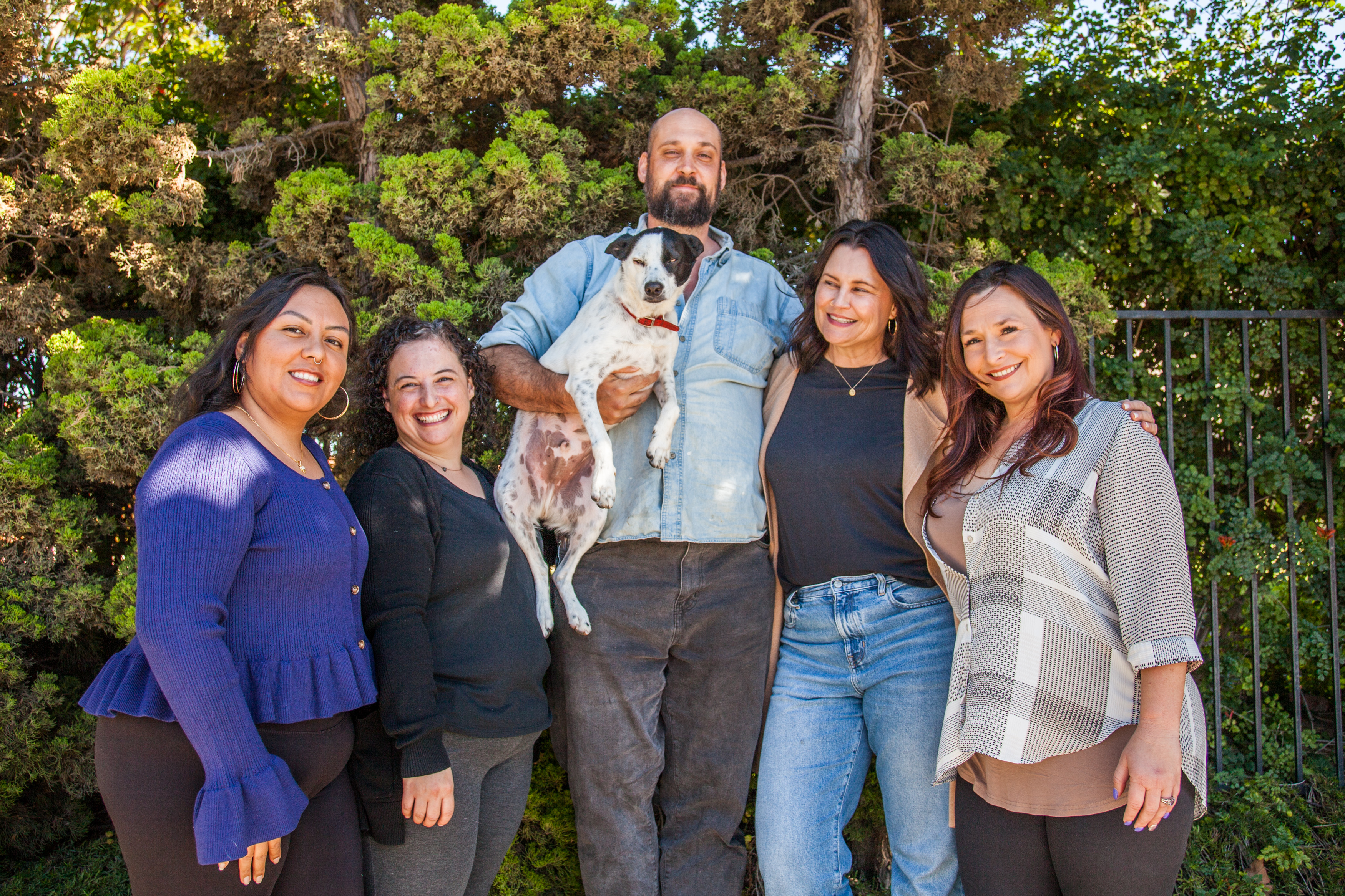 The Catalina Family Therapy team seated together with Dr. Willy, the resident therapy dog.