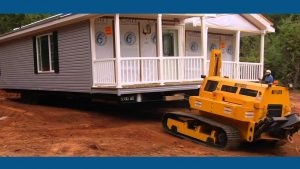 large construction equipment placing a manufactured home on land large construction equipment placing a manufactured home on land