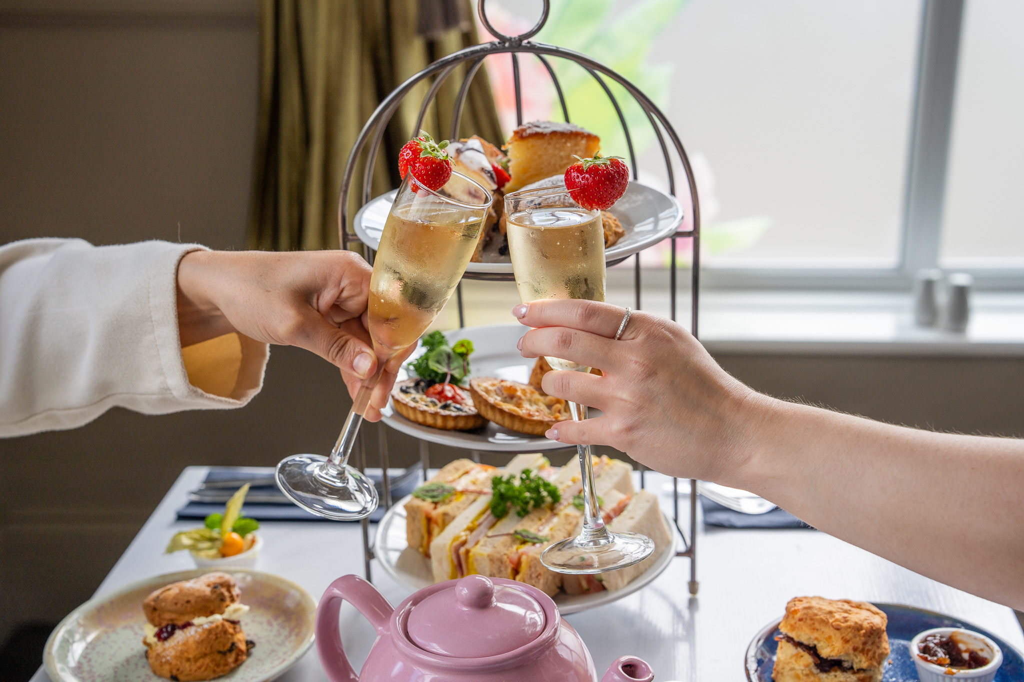 Tea, cakes and sweet treats laid out for afternoon tea