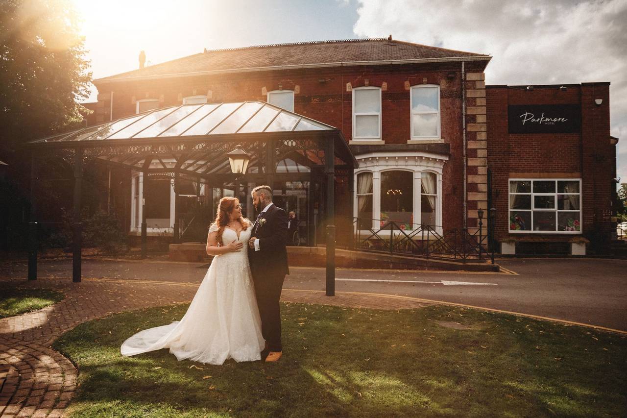 Bride and groom outside the brick entrance of Parkmore Hotel