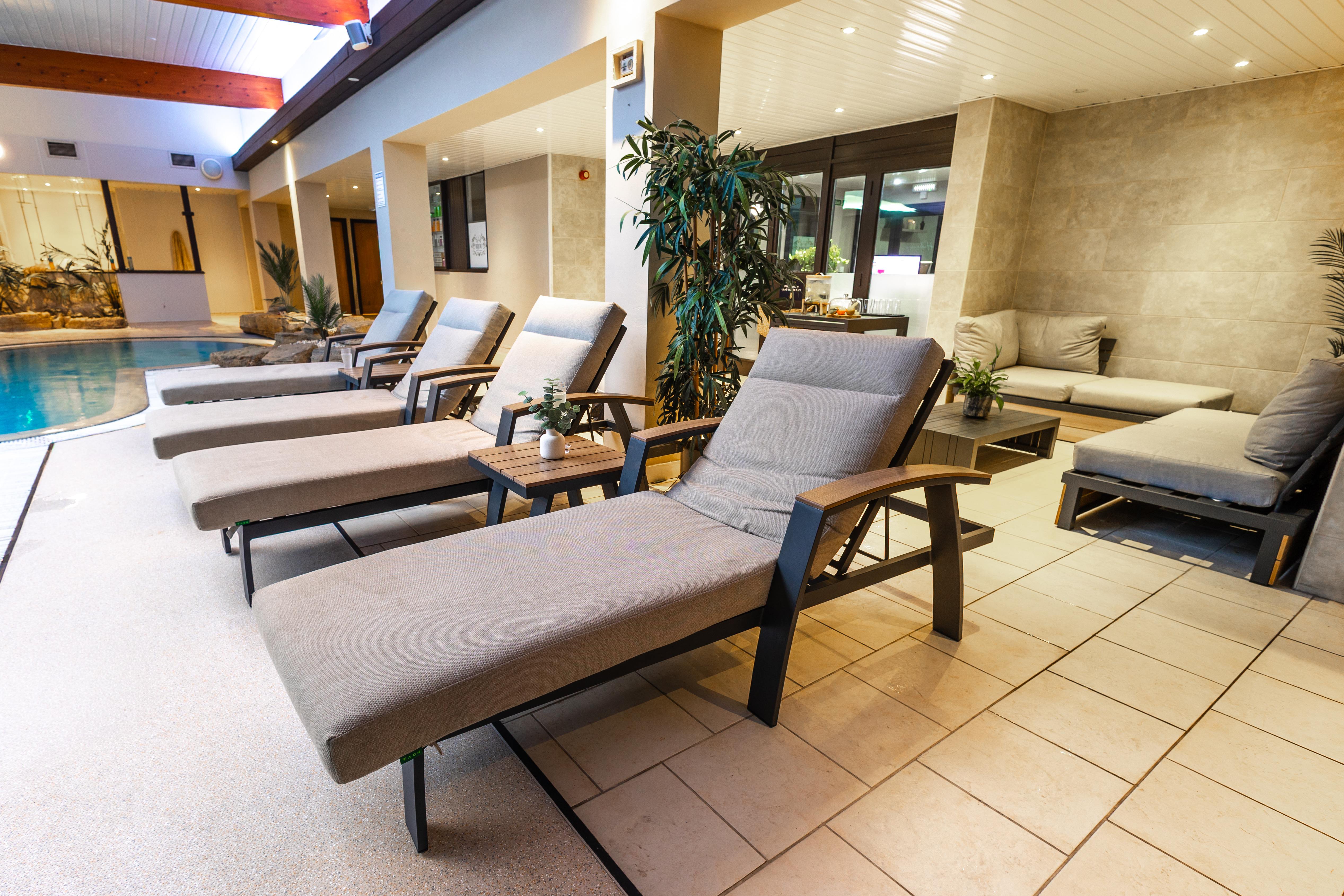 Poolside loungers beside the indoor pool at The Hideaway Spa
