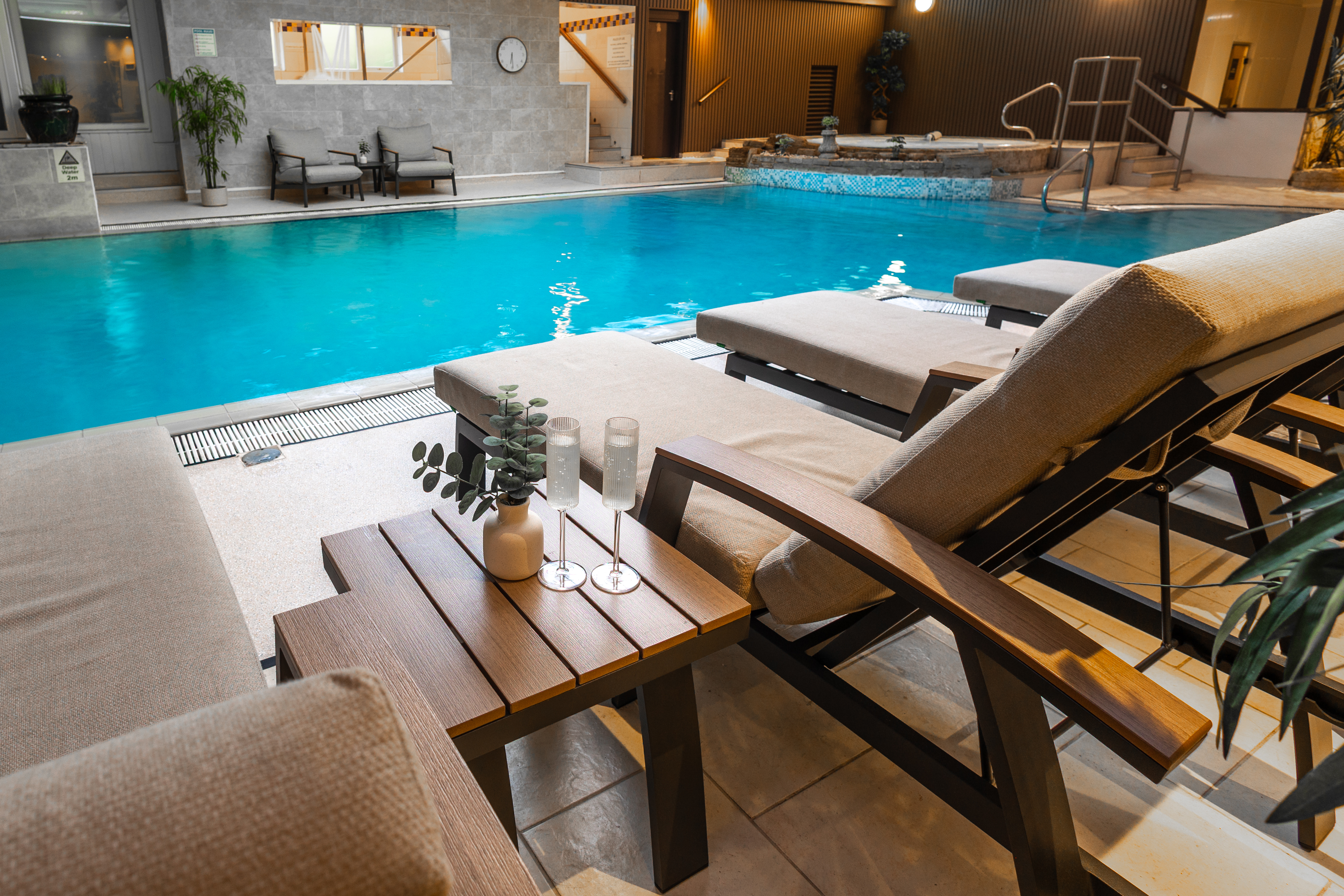 The Hideaway indoor pool with poolside loungers at Parkmore Hotel