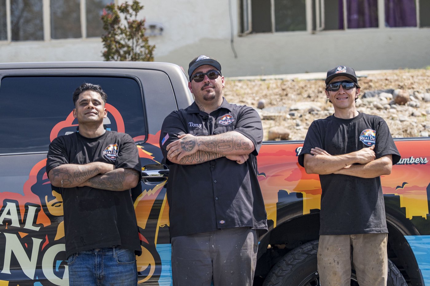 The Real Deal Plumbing SD crew in front of the wrapped truck