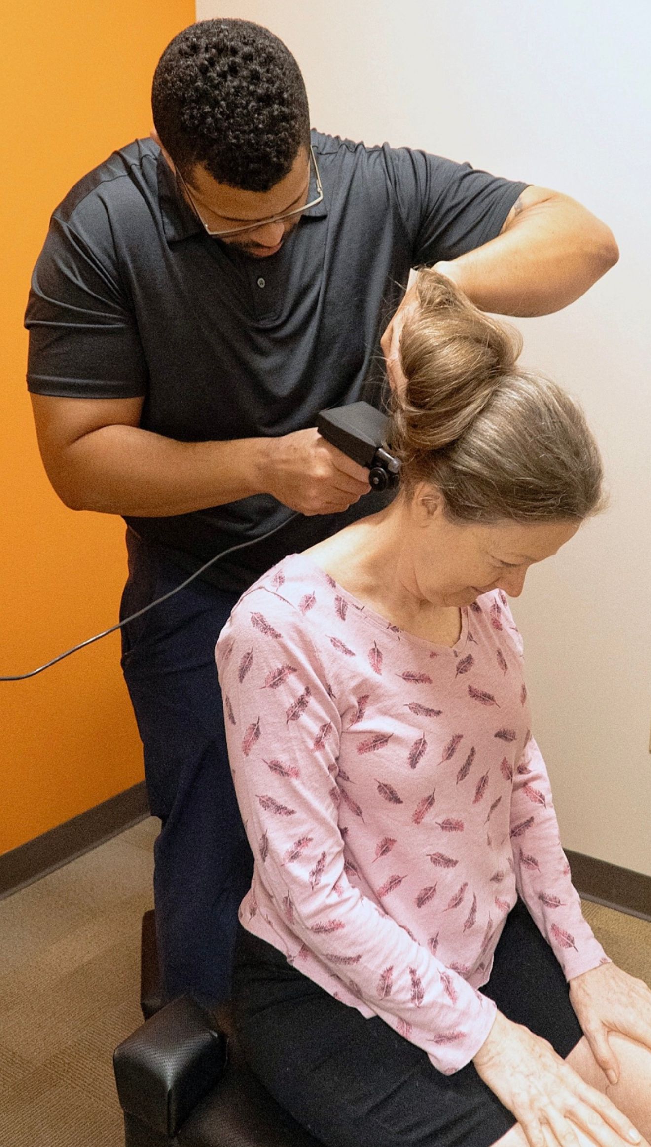 Dr. Cam Daniels performing a nervous system scan in clinic