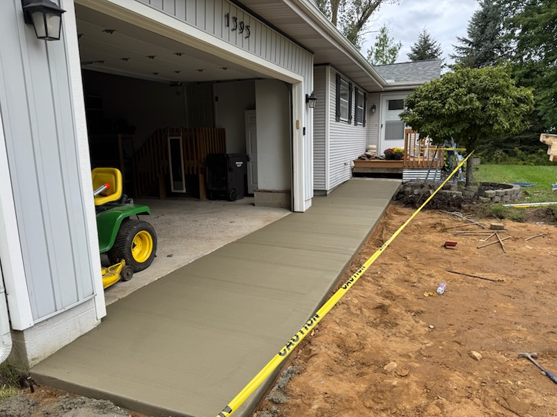 New concrete slab poured alongside a home's attached garage