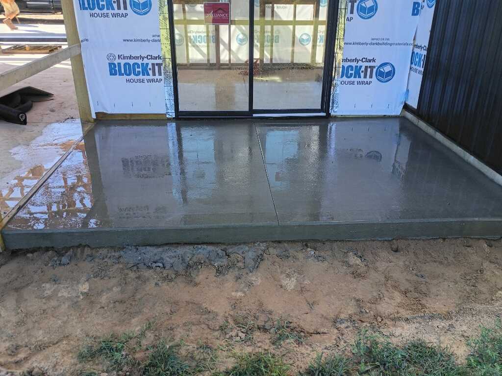 Freshly poured concrete patio slab at a new home construction project in Holland, MI.
