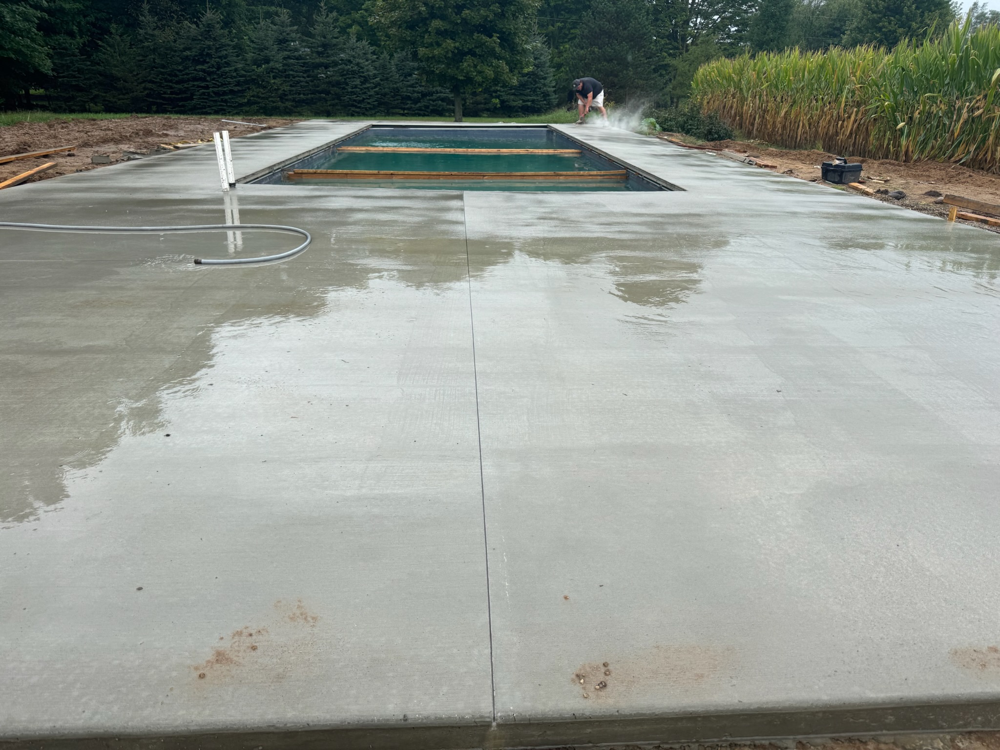 Freshly poured concrete pool deck with a smooth finish
