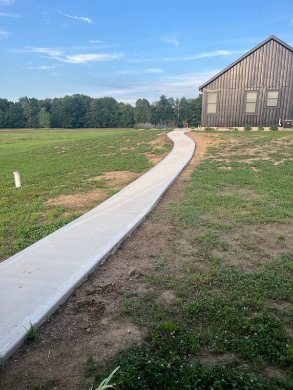 Curved custom concrete walkway leading to a home in Holland, MI.
