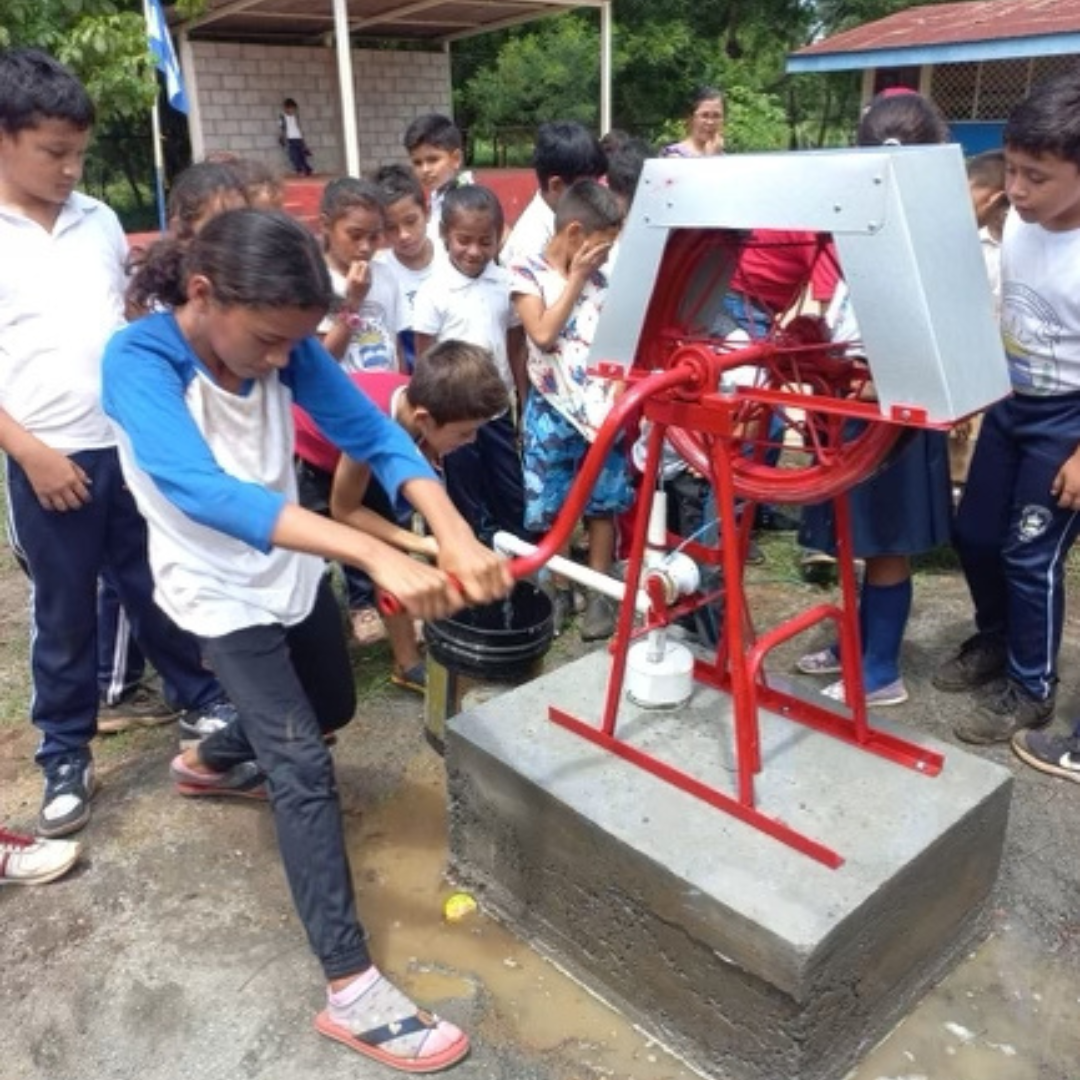 Village School — students at hand pump