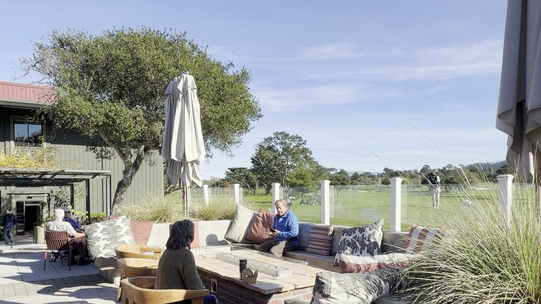 The patio at the Hyatt Regency Monterey, with a fire table and a cypress tree