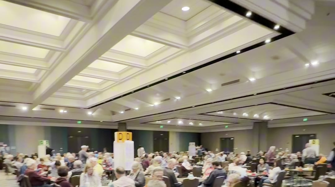The tournament ballroom in Monterey, full of players under a coffered ceiling