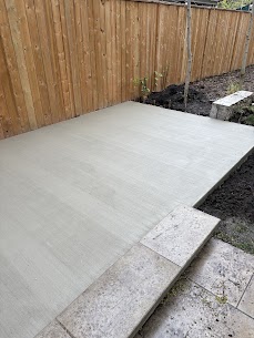 New concrete patio slab in a fenced Toronto backyard