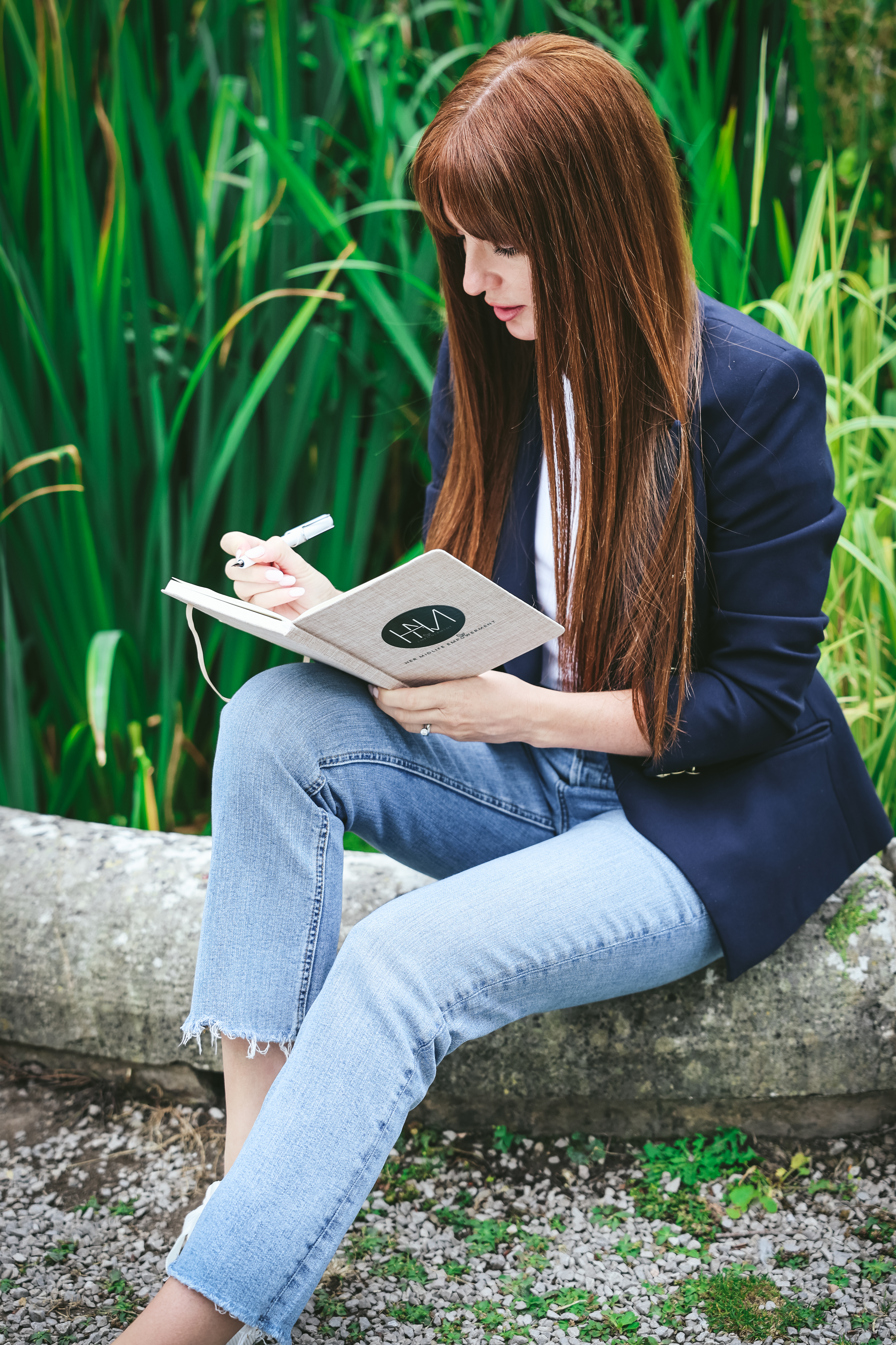 Rachael writing in her HME notebook outdoors