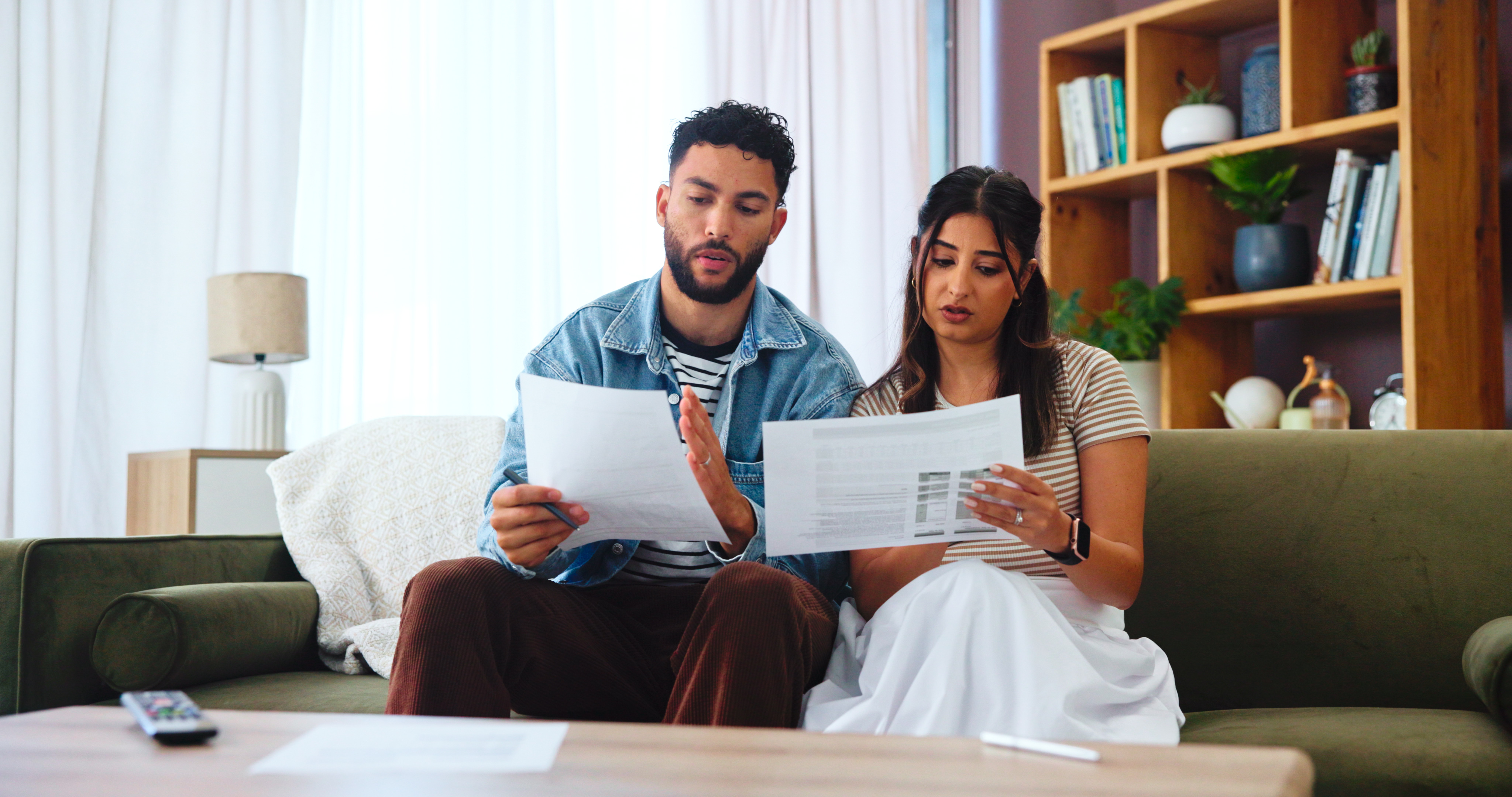 Couple reviewing documents together or a pen on a contract