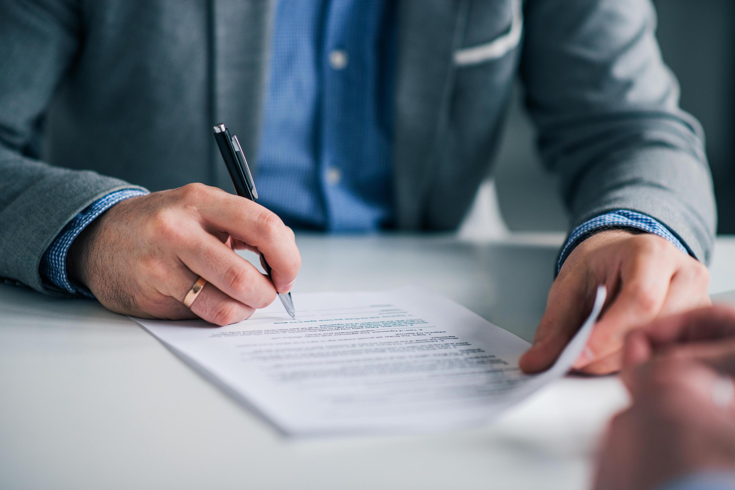 Business professional reviewing financial documents or a signed agreement