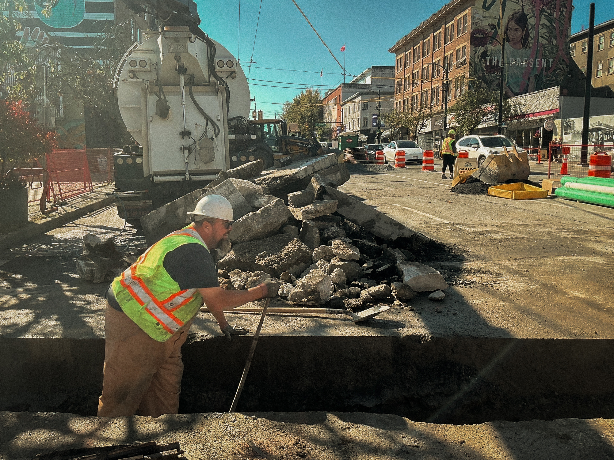 Paving crew placing asphalt on new roadway in British Columbia