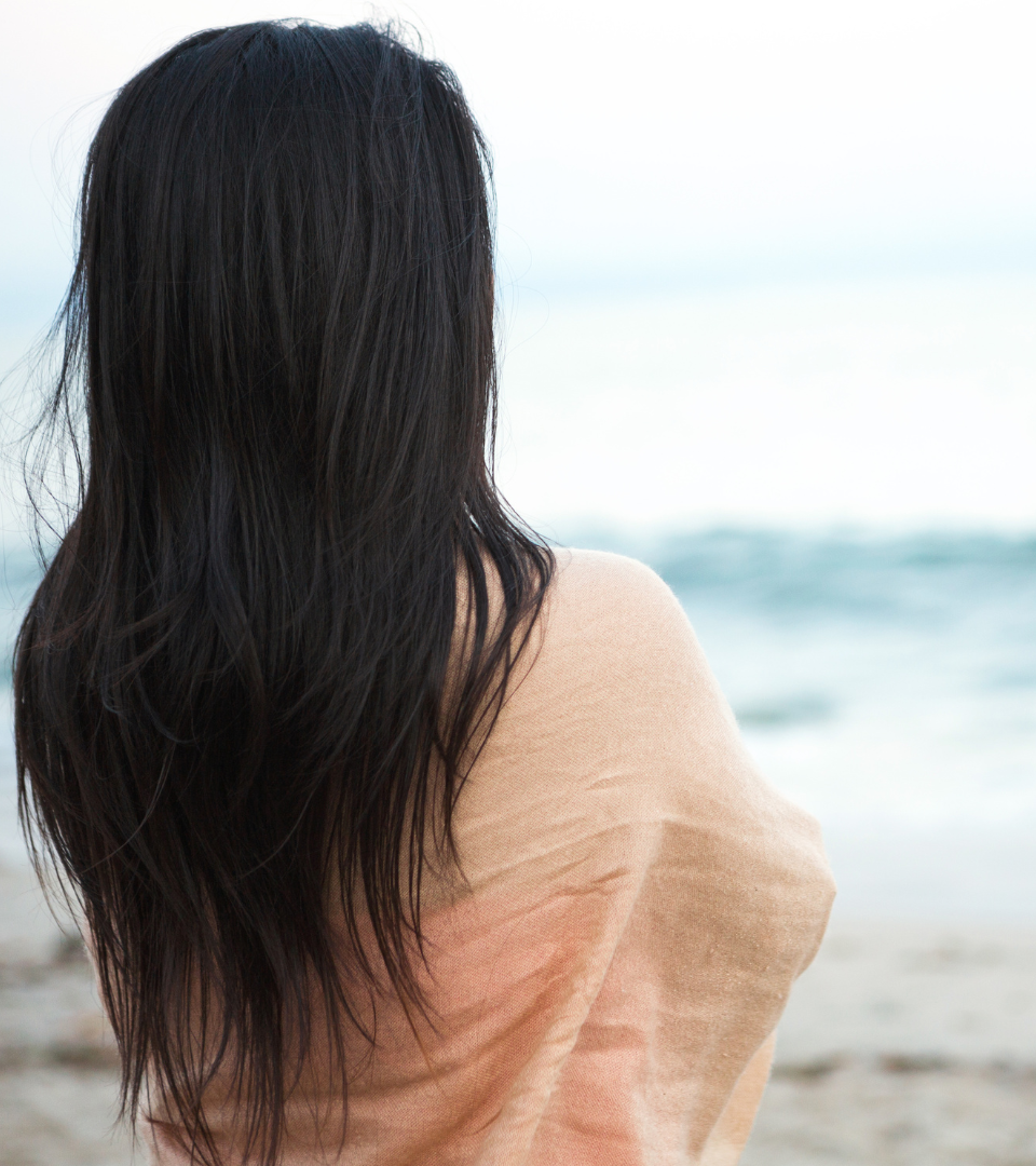 Woman reflecting on her wellness journey