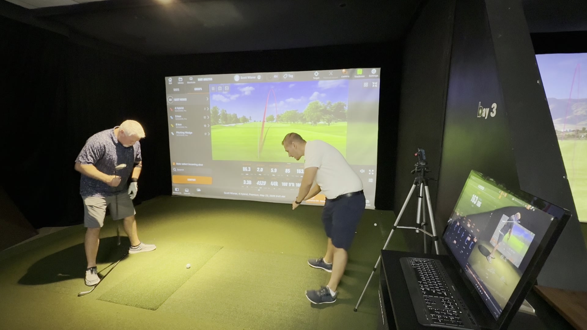 Austin coaching a client through a swing and body screening session at Golf Guru
