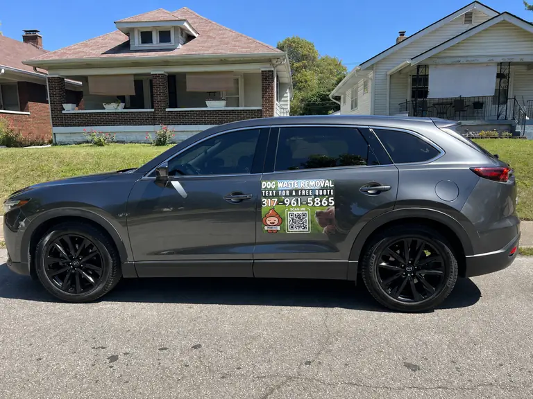 Purge Pros branded dog waste removal service vehicle.