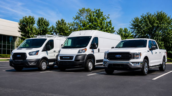 Fleet of freshly detailed commercial vehicles including vans and pickup truck in Massachusetts