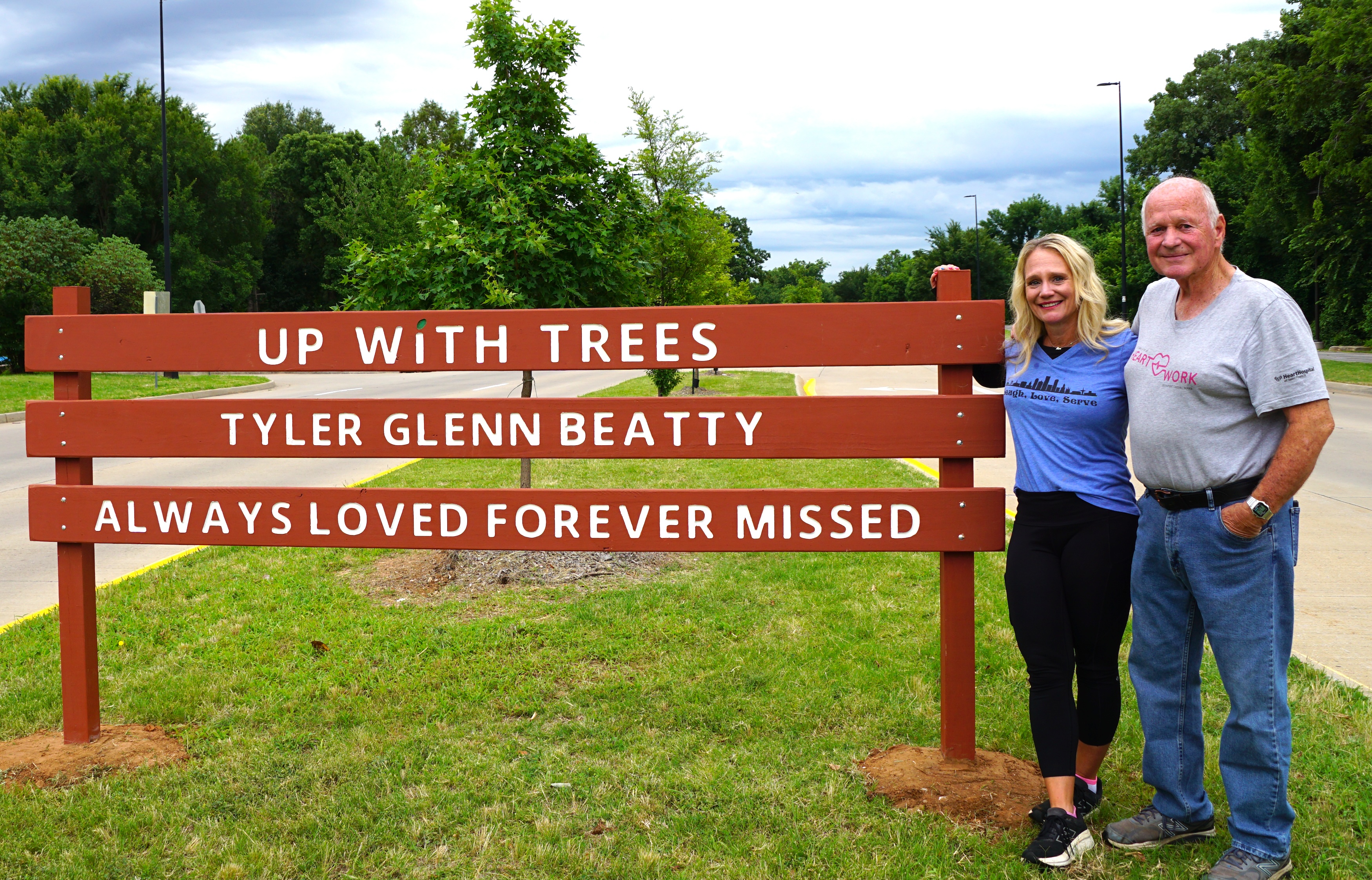 Up With Trees commemorative sign reading "Tyler Glenn Beatty Always Loved Forever Missed" at 52nd Street and Riverside Drive in Midtown Tulsa, Oklahoma