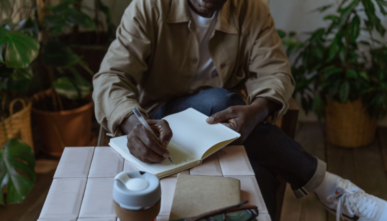 Man in morning routine doing focused journaling and prayer for clarity and purpose"