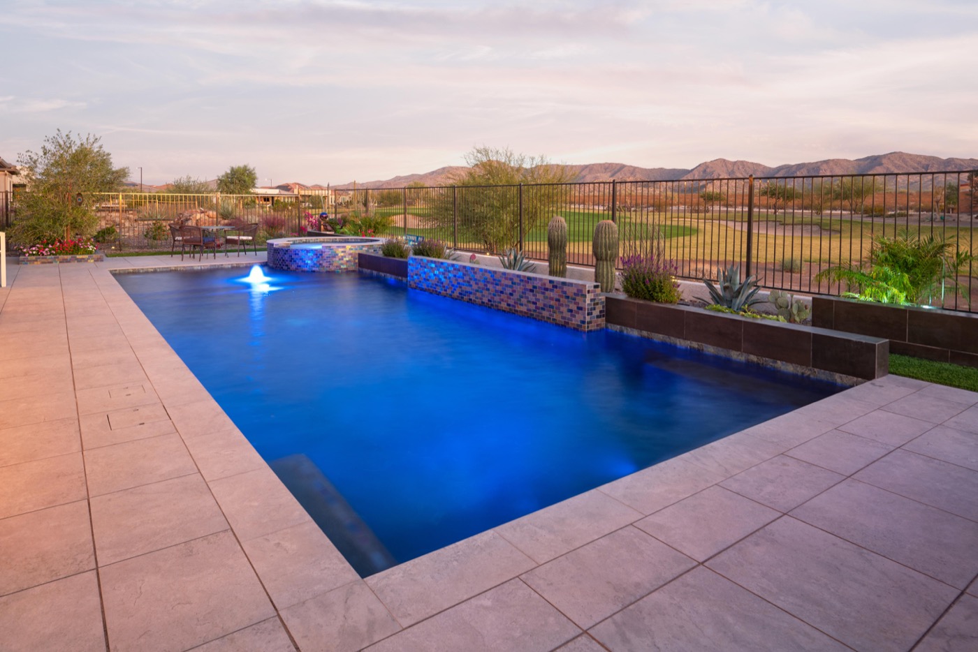 Custom pool with water feature wall and desert landscaping — Phoenix Arizona