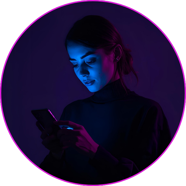 A woman looking down at her smartphone, illuminated by blue and purple neon lighting in a dark environment.
