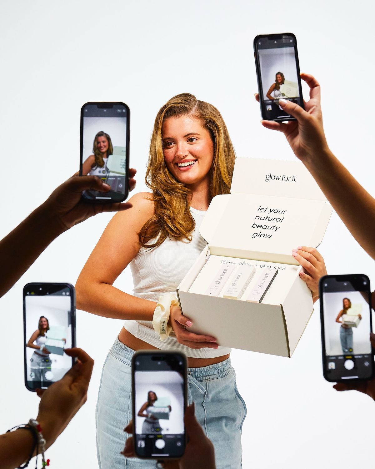 Creator unboxing a product while phones film her