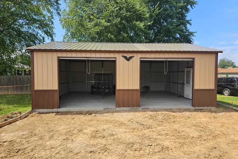 24 by 30 tan and brown two-bay metal garage with both doors open