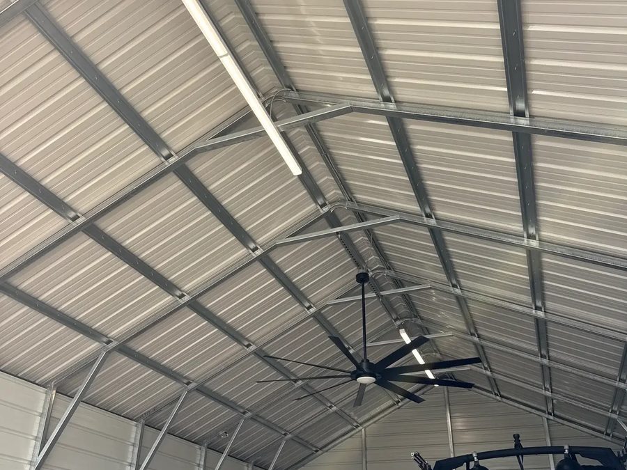 Interior of a finished Outpost building showing galvanized steel trusses, purlins and knee bracing