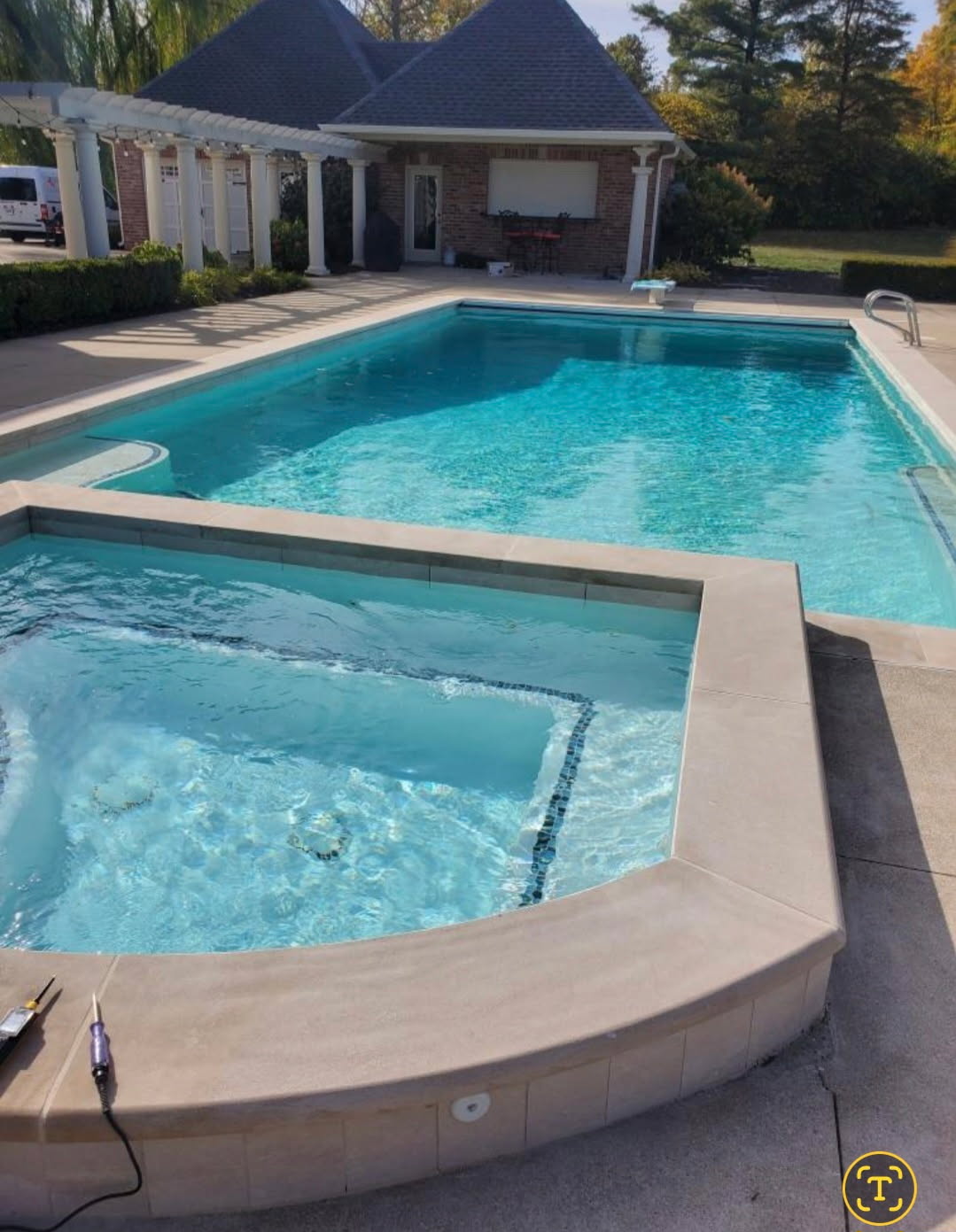 Backyard swimming pool and raised spa with surrounding decking