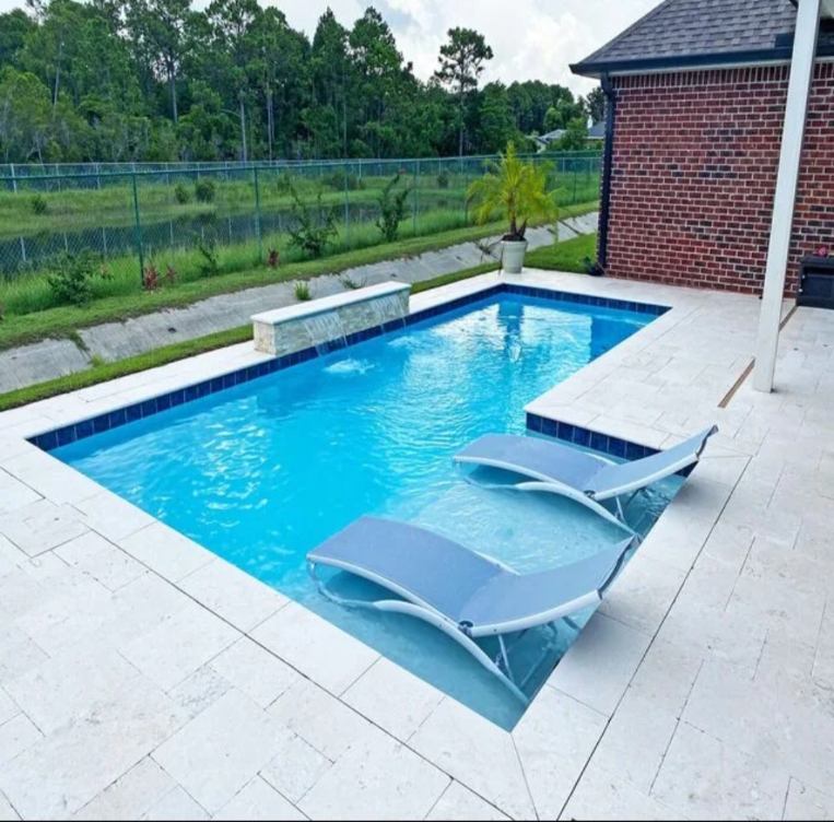 Modern swimming pool with a sun shelf and white lounge chairs