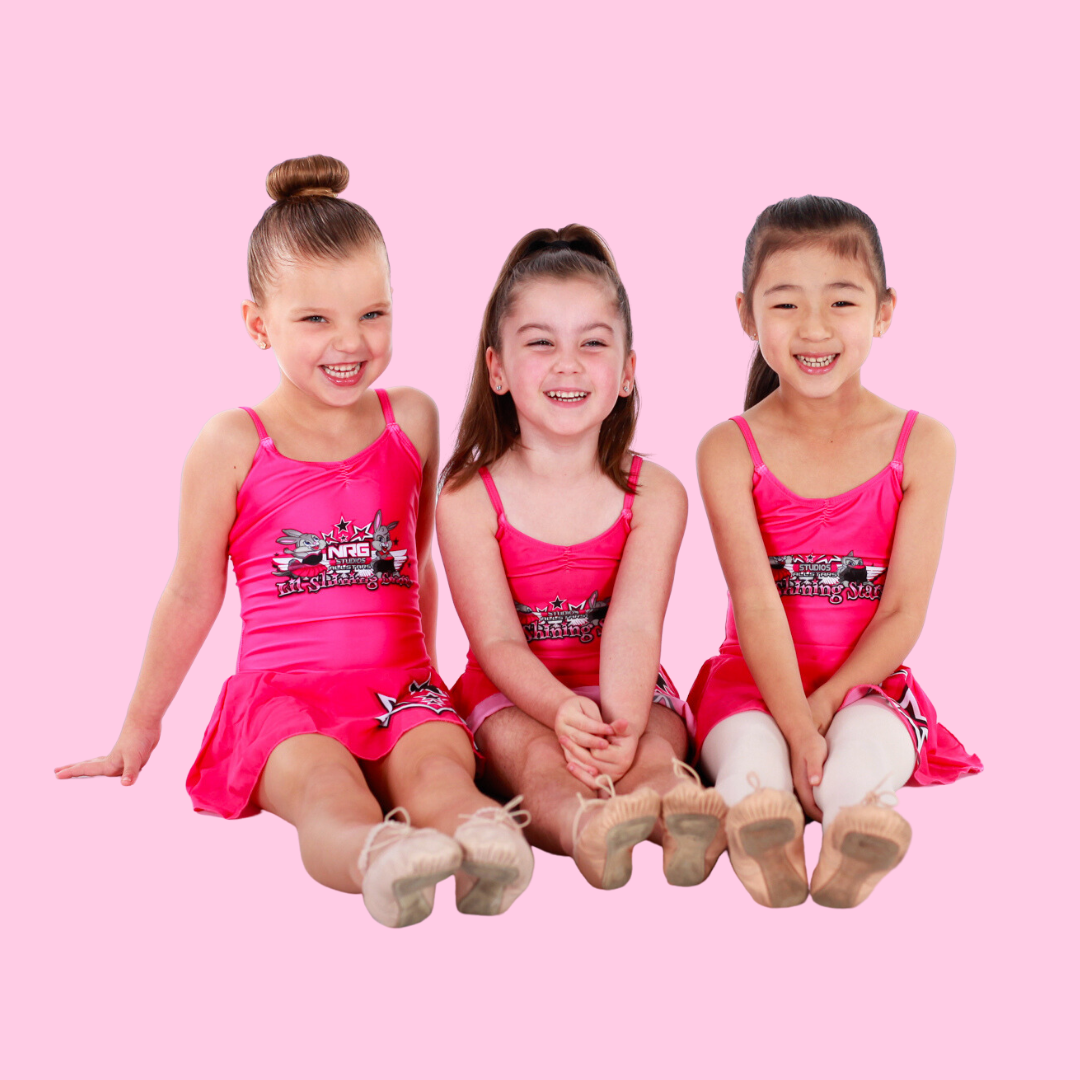 Three preschool dancers enjoying their time at NRG Studios Allstars, smiling and laughing during preschool dance classes in Wollongong, promoting kids' dance and cheerleading