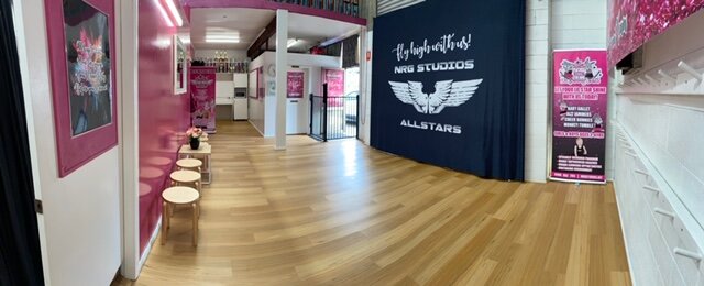 Spacious and welcoming pink and black waiting room at NRG Studios Allstars, the top dance and cheerleading studio in Wollongong for kids and families