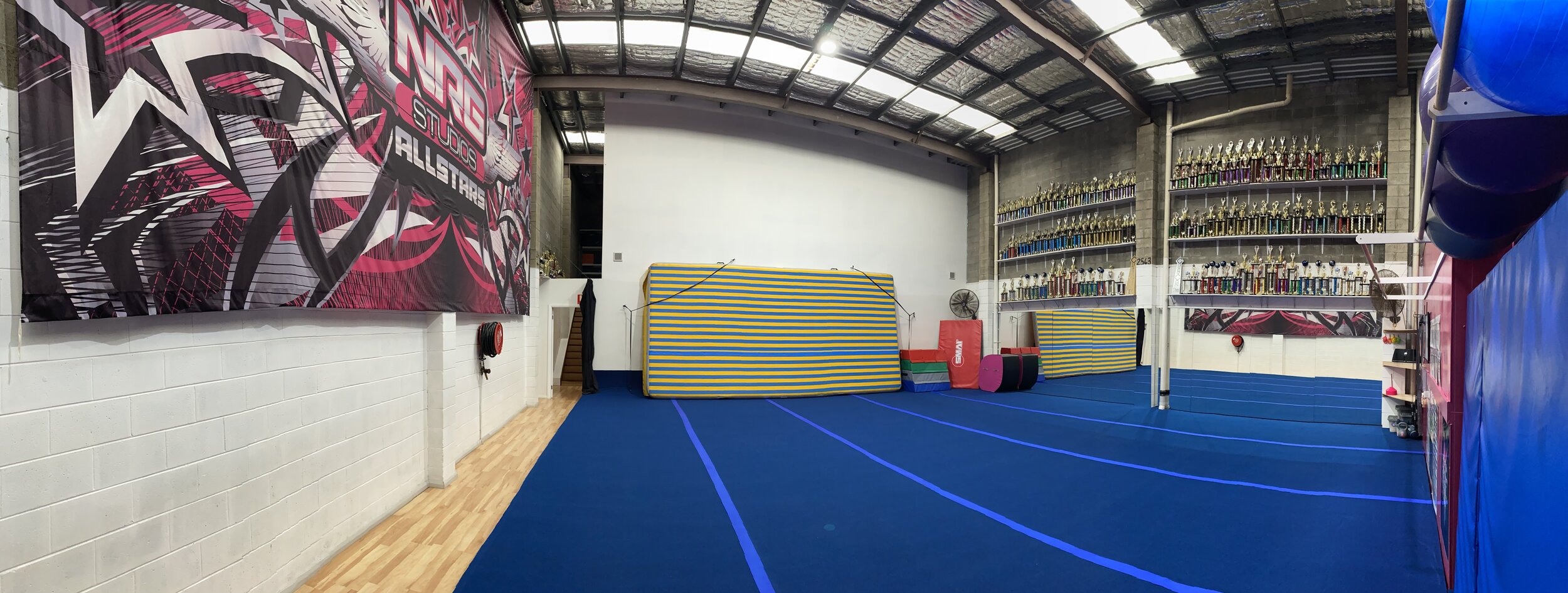 Cheerleading room at NRG Studios Allstars in Wollongong, featuring a large fully sprung floor for safe cheerleading classes and training