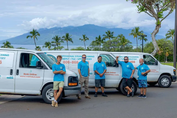 CSI Maui cleaning team posing in front of service vans on Maui