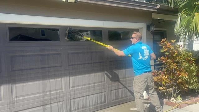 CSI worker cleaning exterior windows with precision, demonstrating thoroughness and pride in delivering spotless results