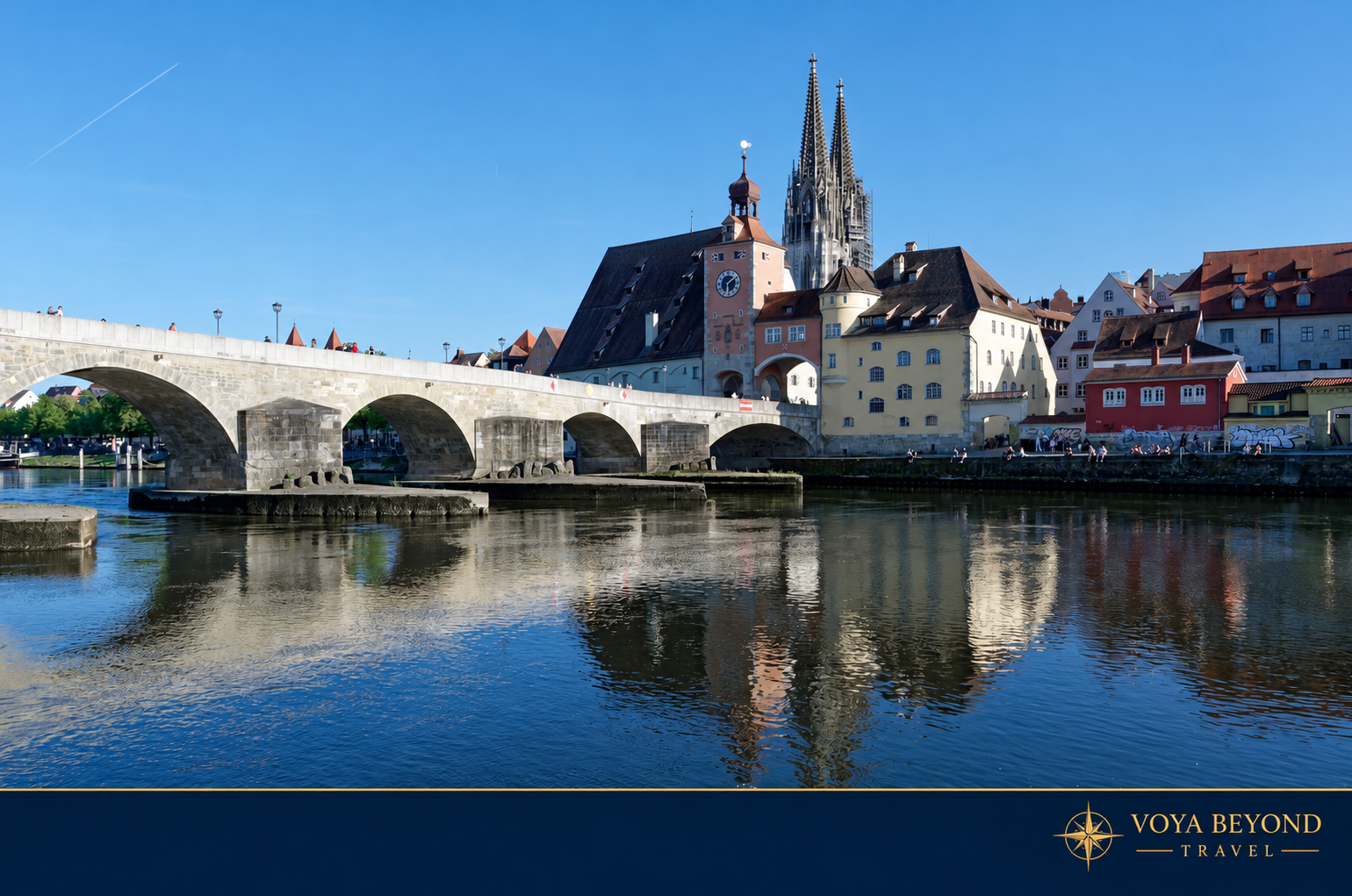 The Stone Bridge crosses the Danube in front of Regensburg’s cathedral and riverfront buildings.