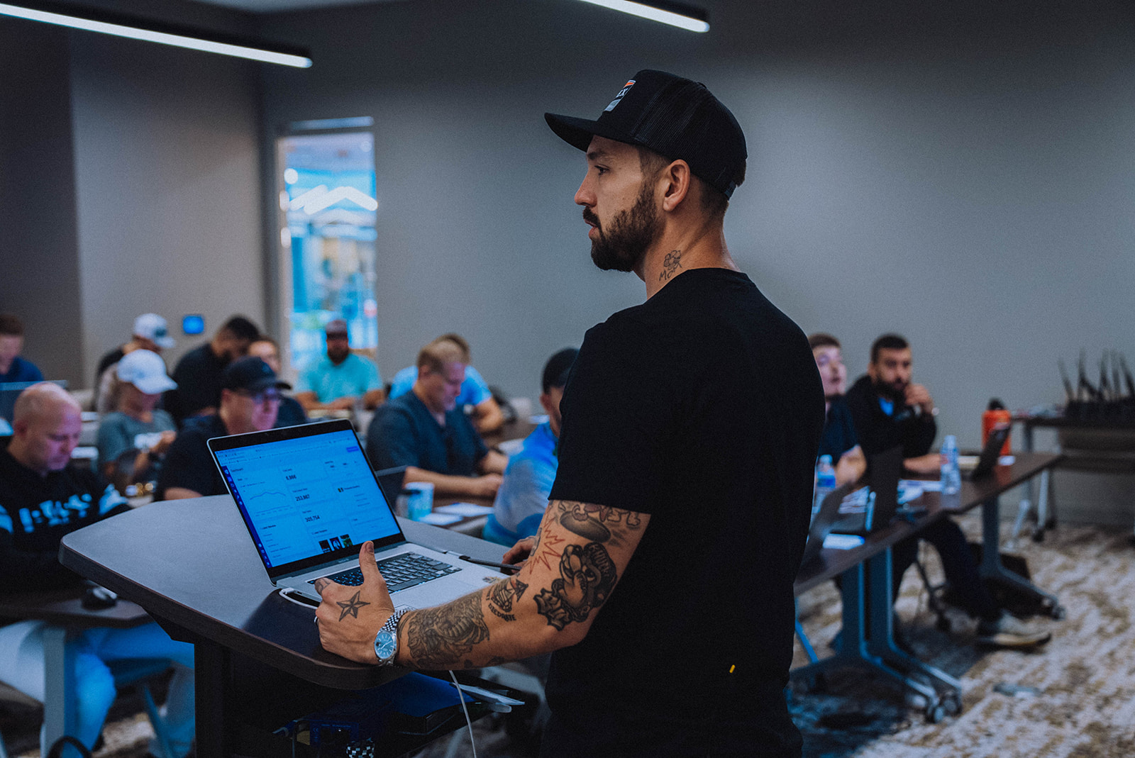 Sales team working on laptops in an office