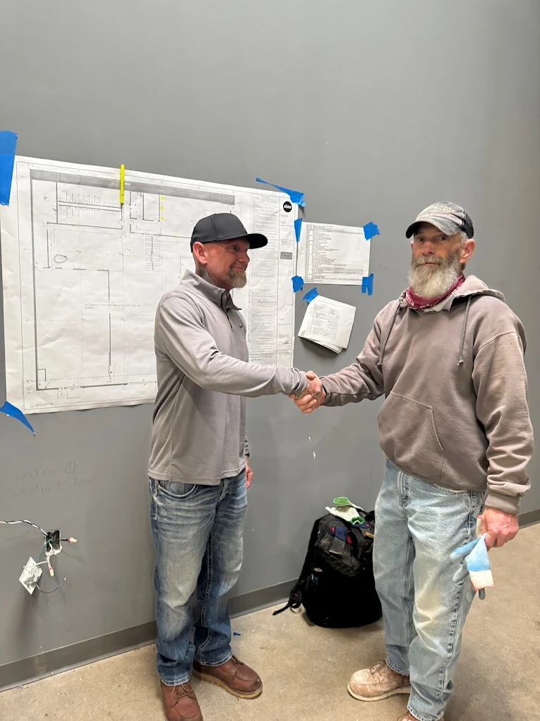 Jason Trester shaking hands with a Minnesota business client — trust, partnership, and proven results