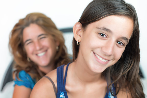 Mother and daughter smiling, happy