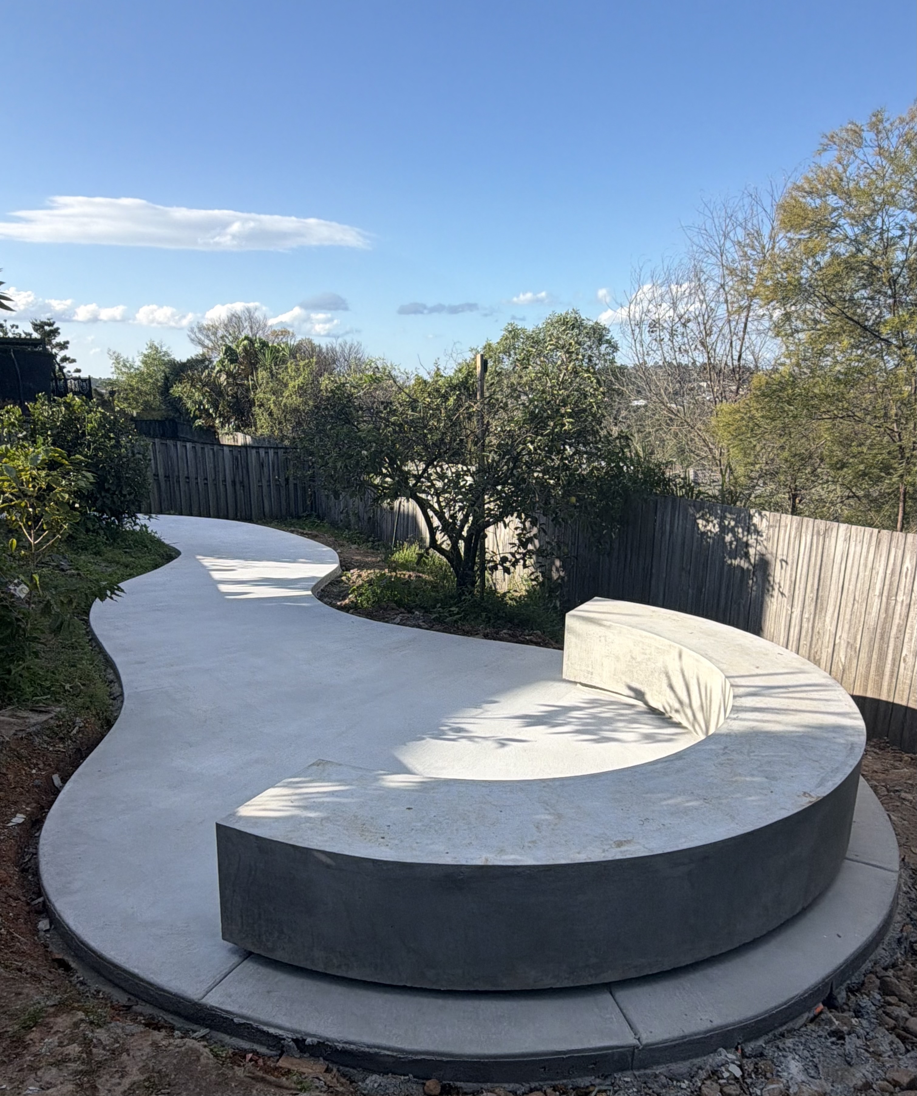 Architectural floating curved concrete seating by TCG Concrete Co.