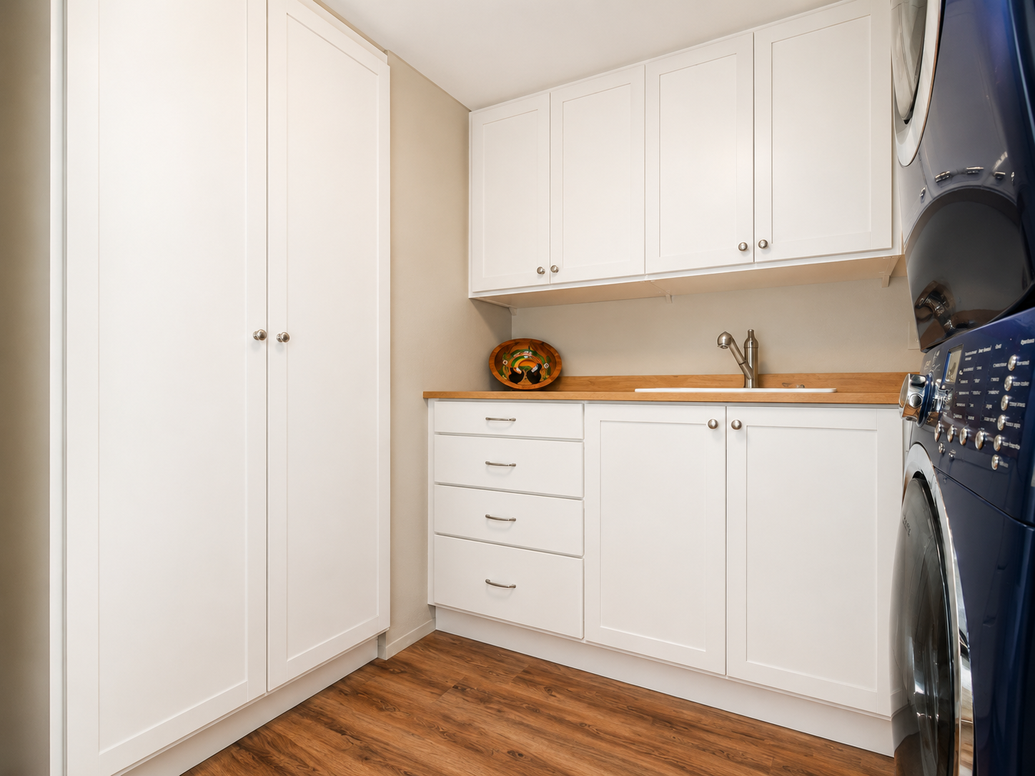 Organized pantry and laundry storage with custom shelving