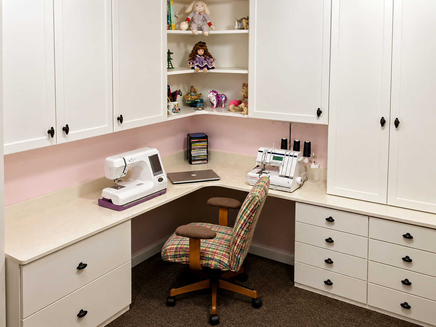Organized custom craft room with cabinetry and work surfaces