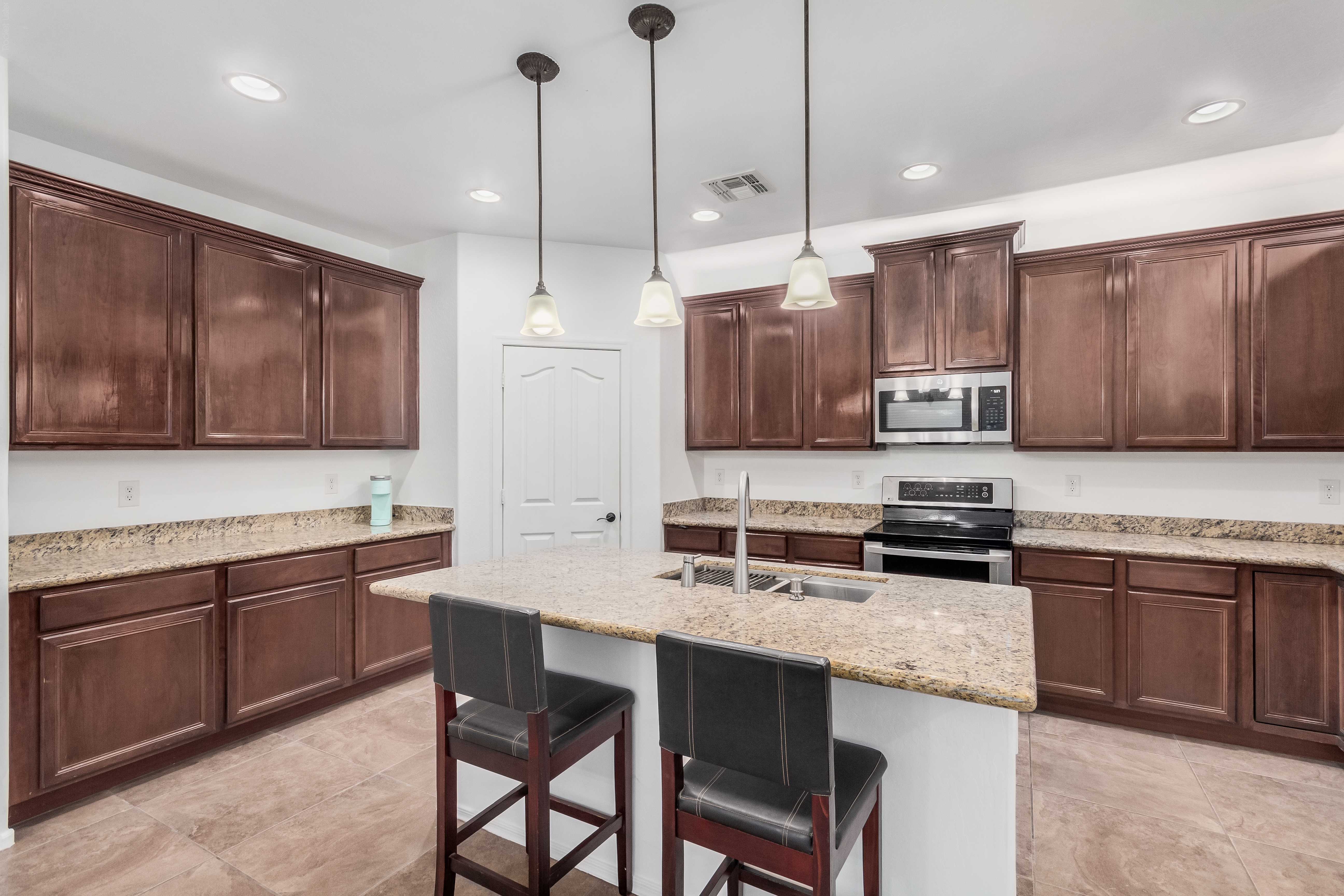 Front exterior of 18663 W Vogel Ave Goodyear AZ, an updated 5 bedroom 4 bathroom family home for sale by owner with 3-car garage on 0.26 acre lot, listed at $529,000
