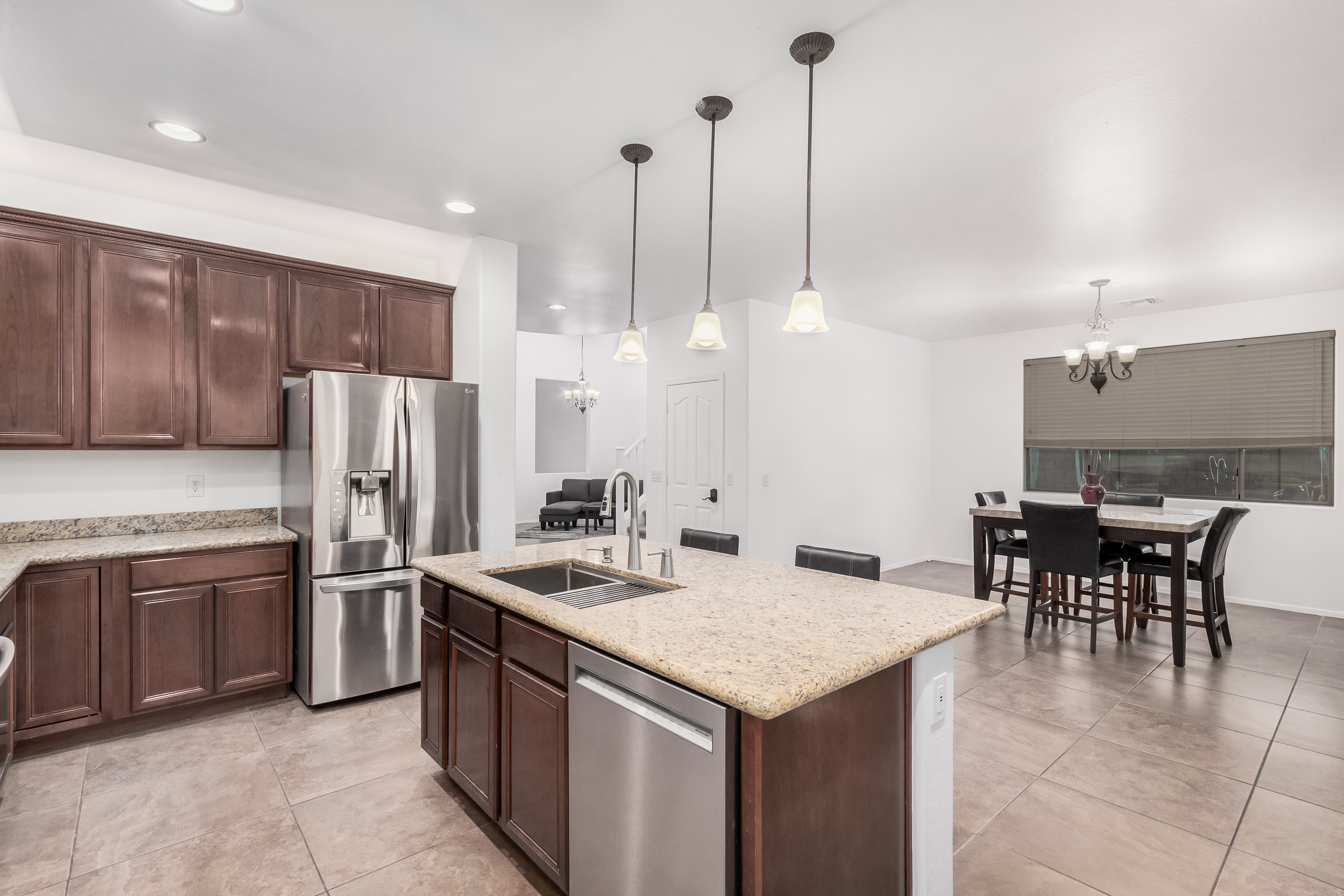 Great room living space at 18663 W Vogel Ave with 24-inch tile flooring