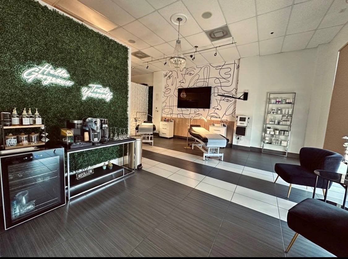 Main lounge with green wall, neon signs, and beverage bar