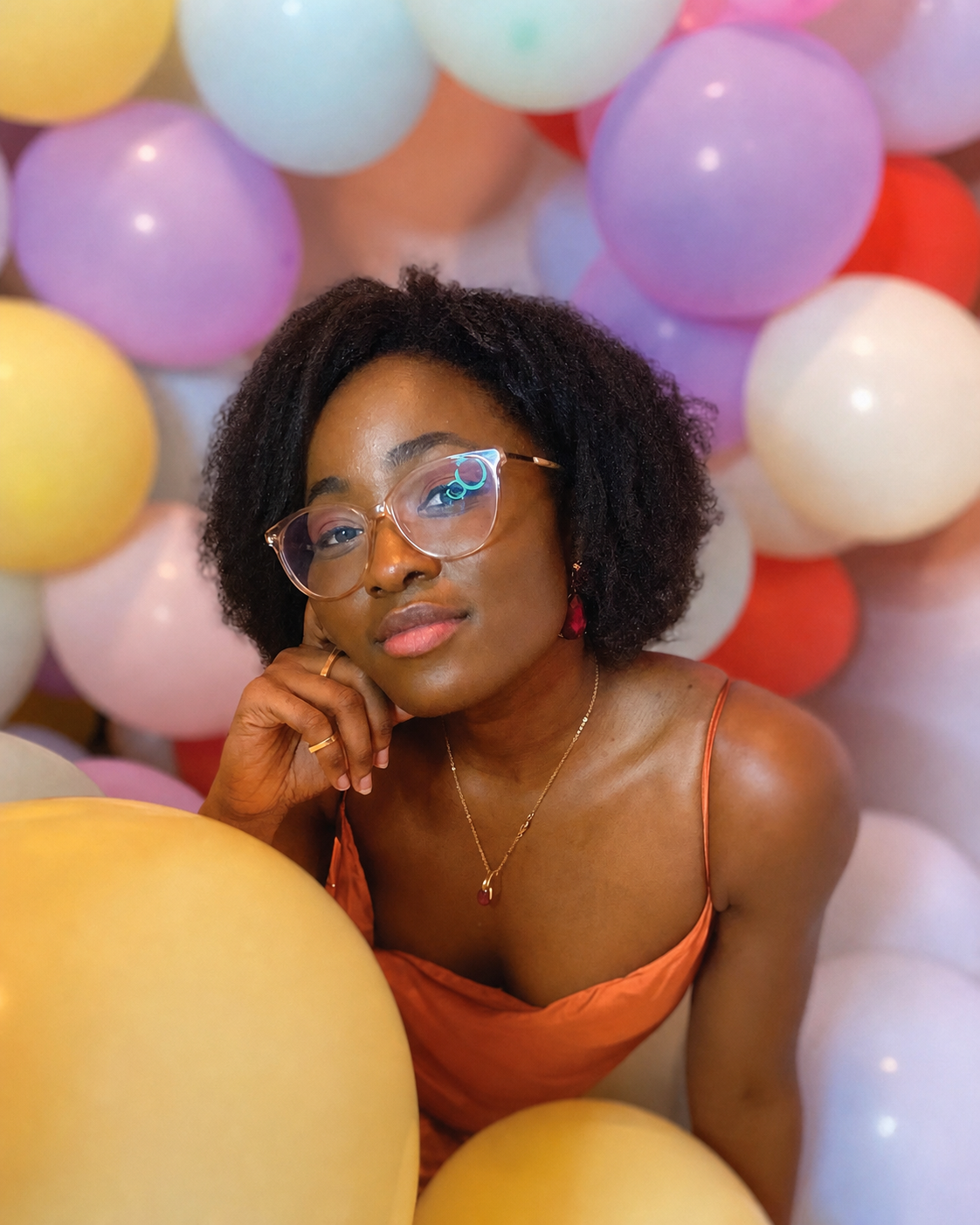 Aurélie Kadjo surrounded by colorful balloons