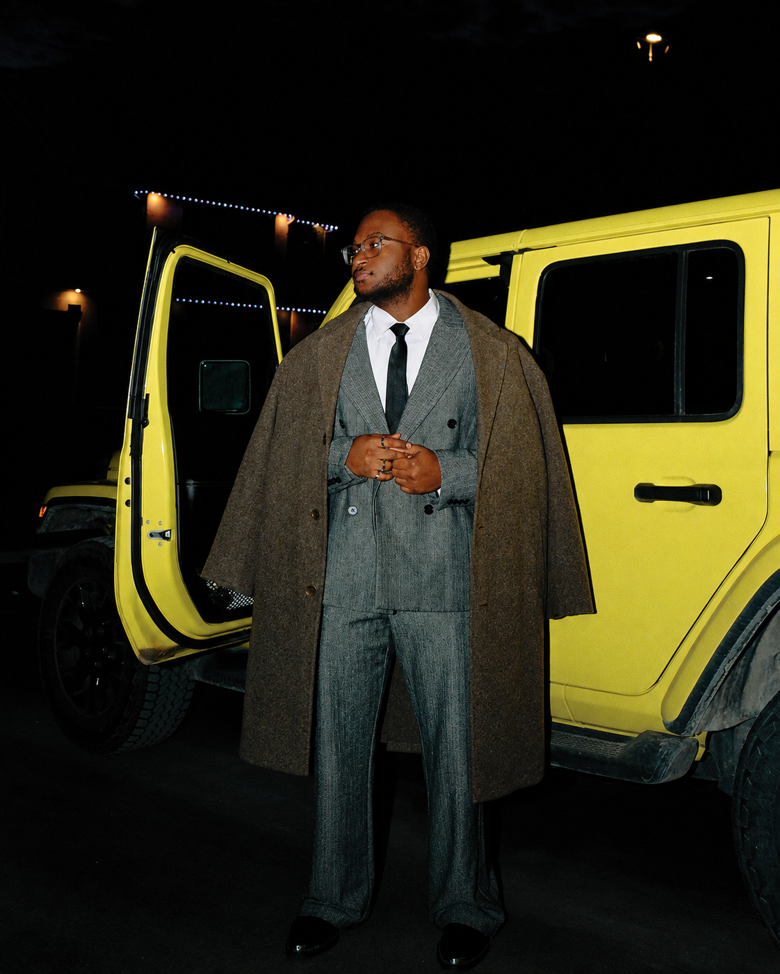 Michel Grandin beside a yellow vehicle at night